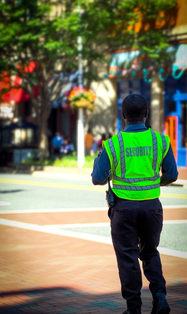 An Image of Security guard in a neon green vest
