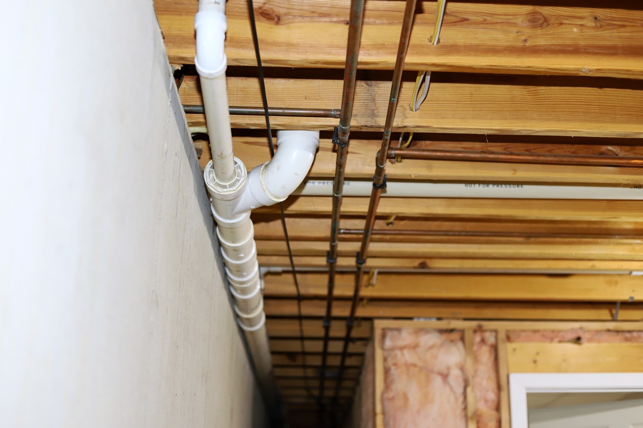 Waste PVC pipe drainage system inside home in a basement