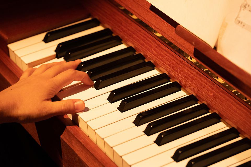 pressing keys on a piano