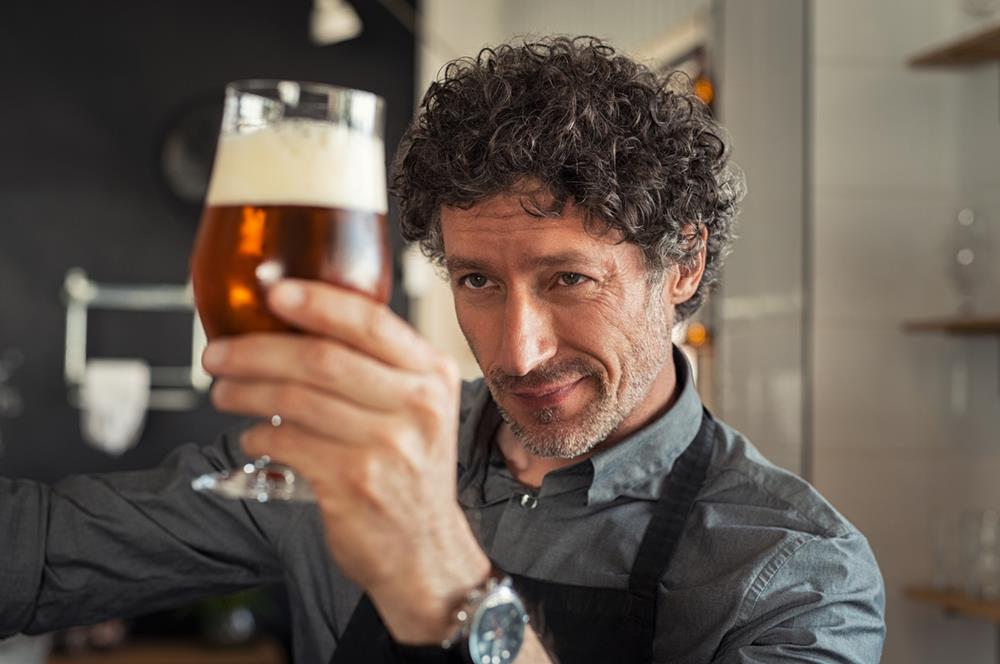 Man checking beer quality