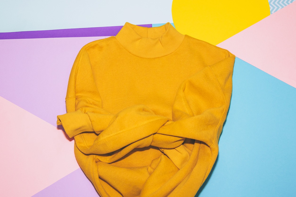 Yellow sweater on Memphis style background