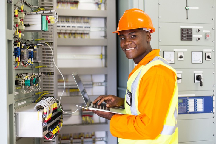 african electrical worker using laptop computer