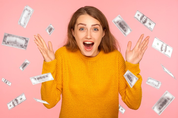 woman looking at camera with big eyes, absolutely shocked of money rain falling from up.