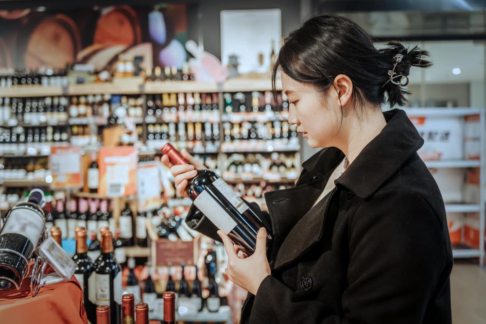 Woman selecting wine in a store