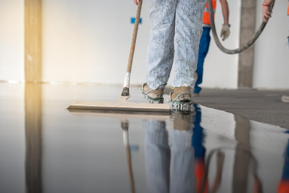 A worker applying epoxy flooring