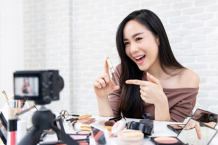 Beautiful Asian woman beauty vlogger recording makeup tutorial