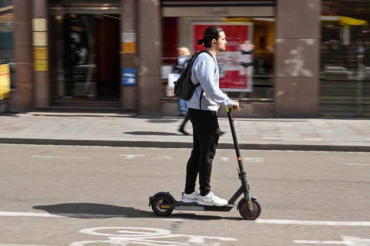 Person riding an electric scooter with blurred motion