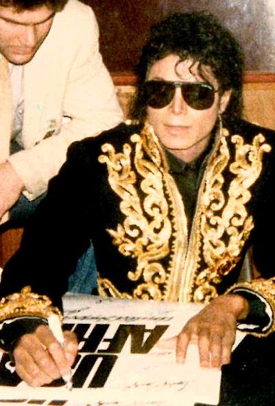 Jackson signing a “We Are the World” poster in 1985
