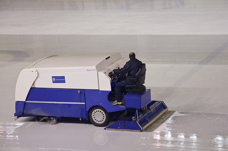 An ice resurfacer lays down a layer of clean water, which will freeze to form a smooth ice surface