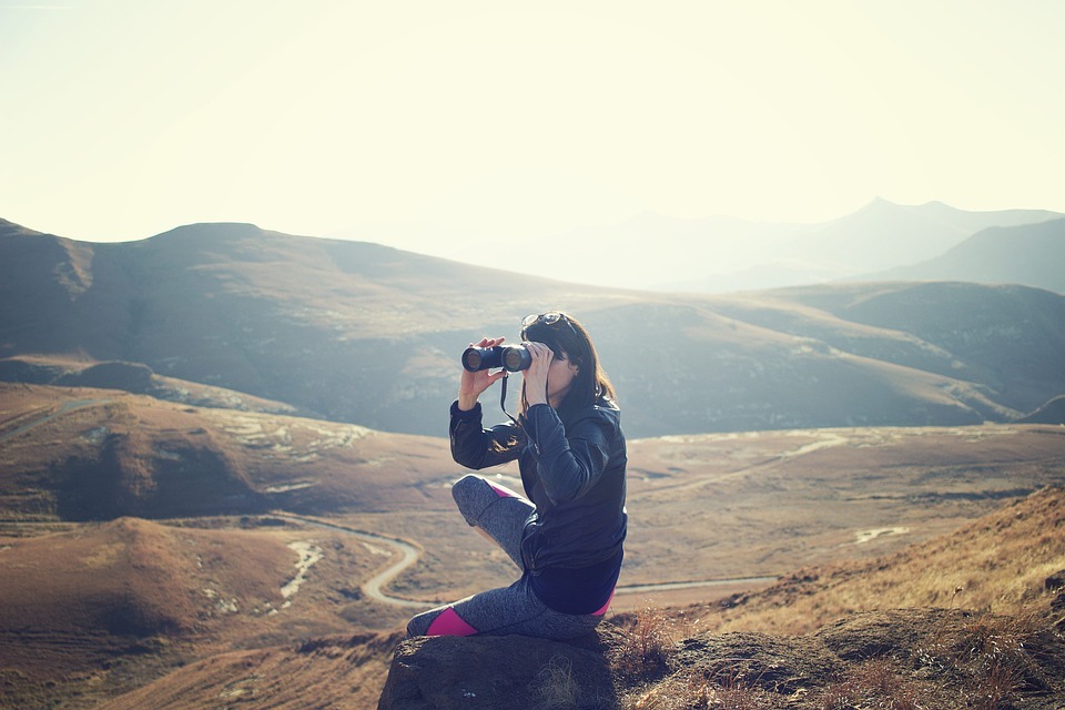 woman using binoculars outdoors