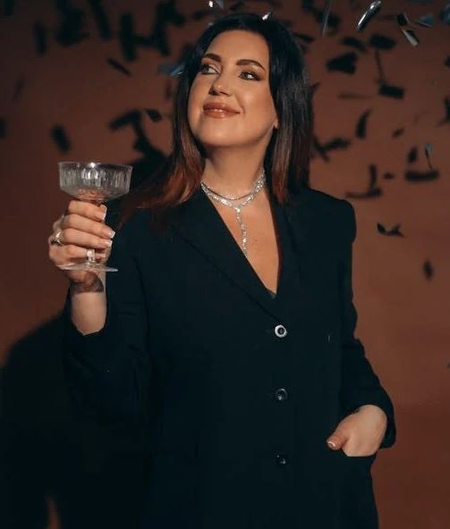 woman with champagne glass celebrating New Year’s Eve
