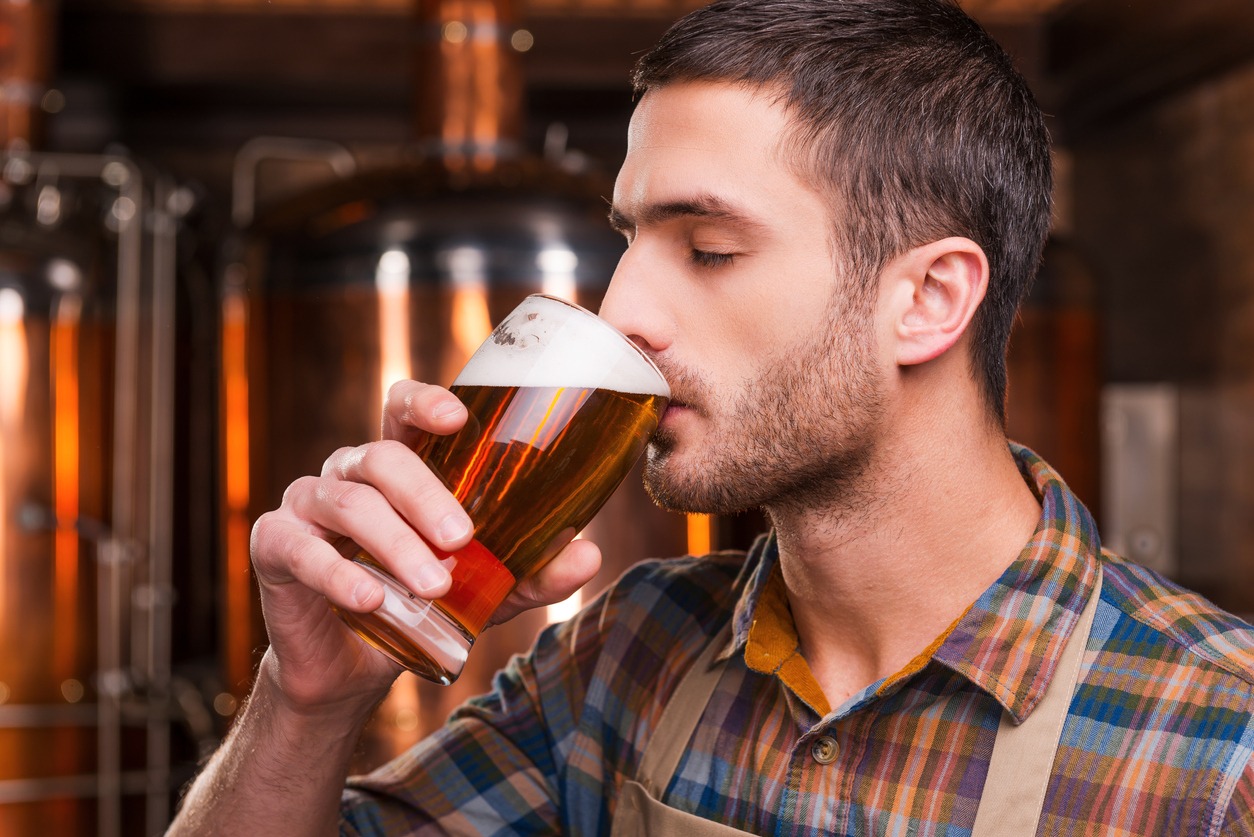 man drinking freshly-brewed beer