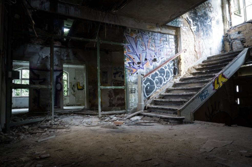 An abandoned building with graffiti on the wall
