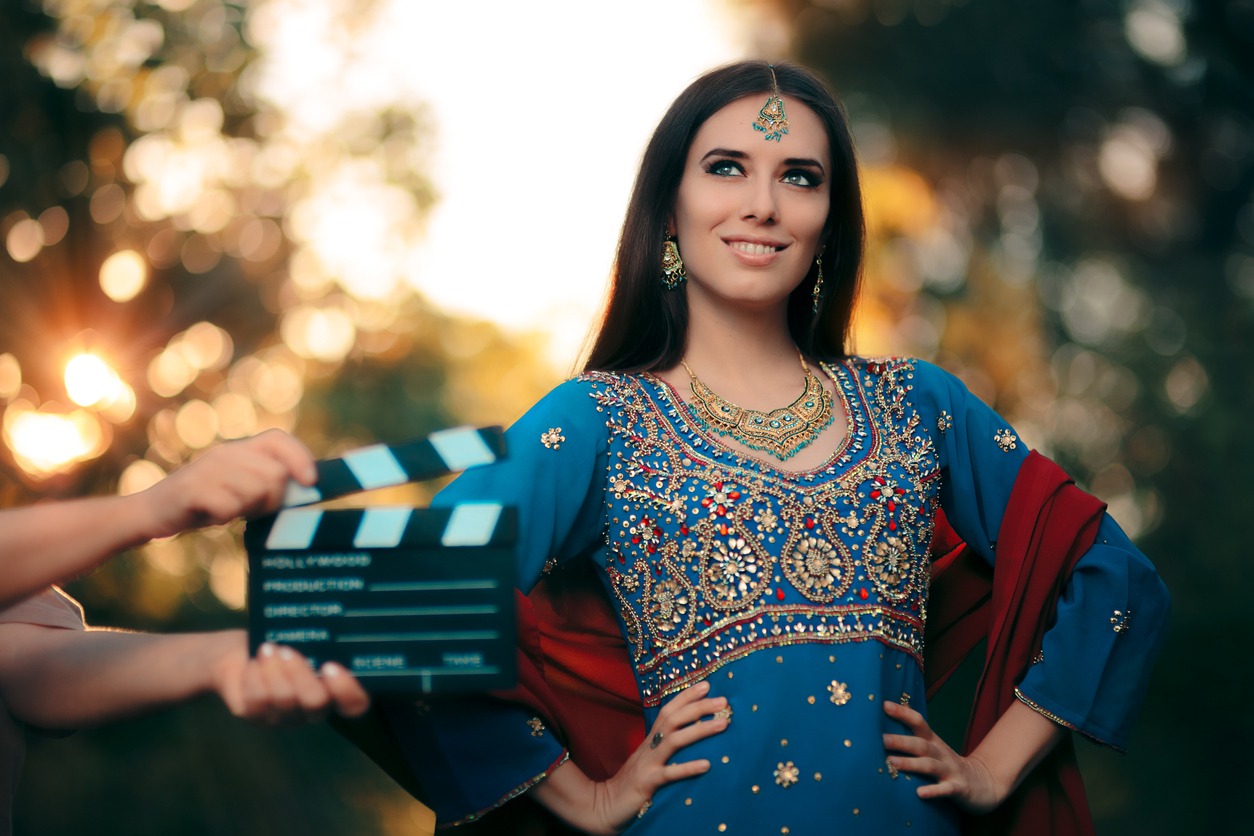 Cinema star wearing a salwar kameez with earrings, mangtika and necklace
