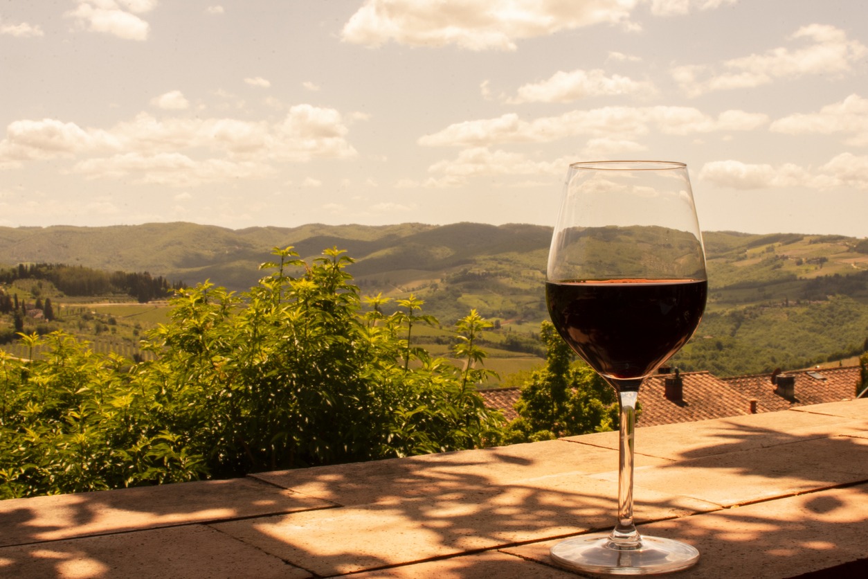 Glass of red wine on the hills of Tuscany in Italy