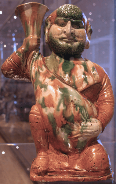 Glazed earthenware figurine depicting a foreigner holding a wineskin from the Tang Dynasty