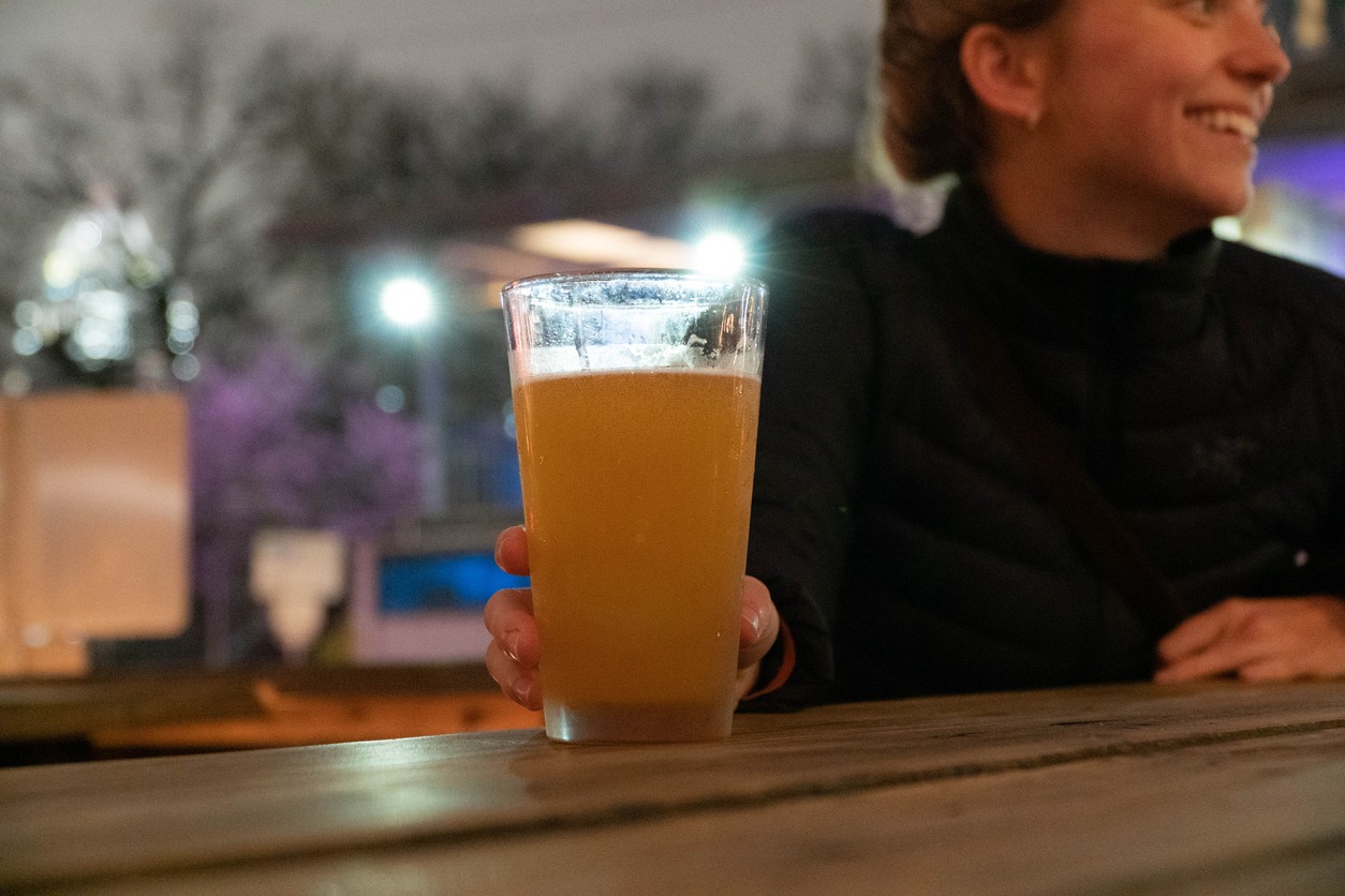 a woman having a glass of beer in Austin, Texas