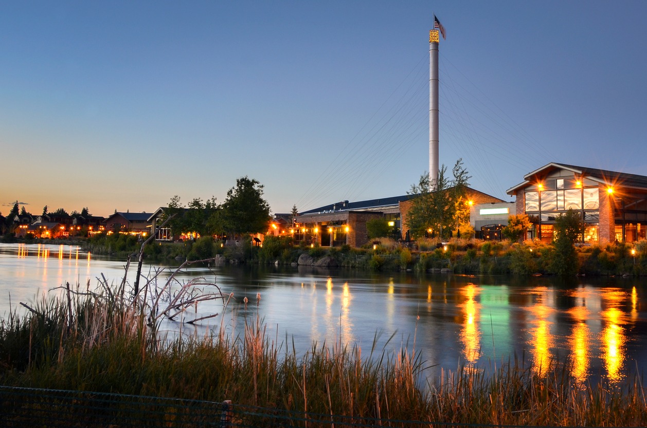 renovated old industrial buildings at sunset along the river in Bend, Oregon