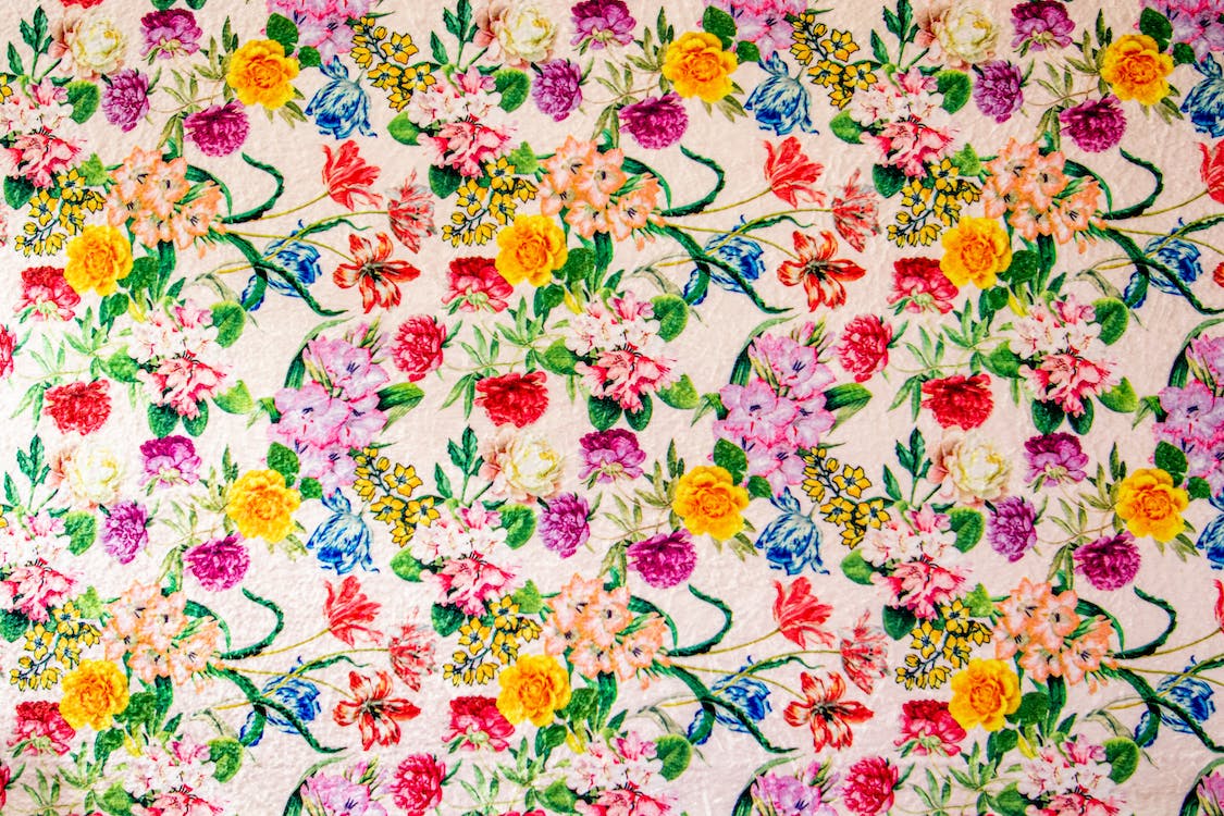 white pink and green floral textile