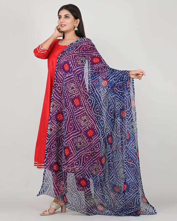 woman in a red dress with blue printed shawl