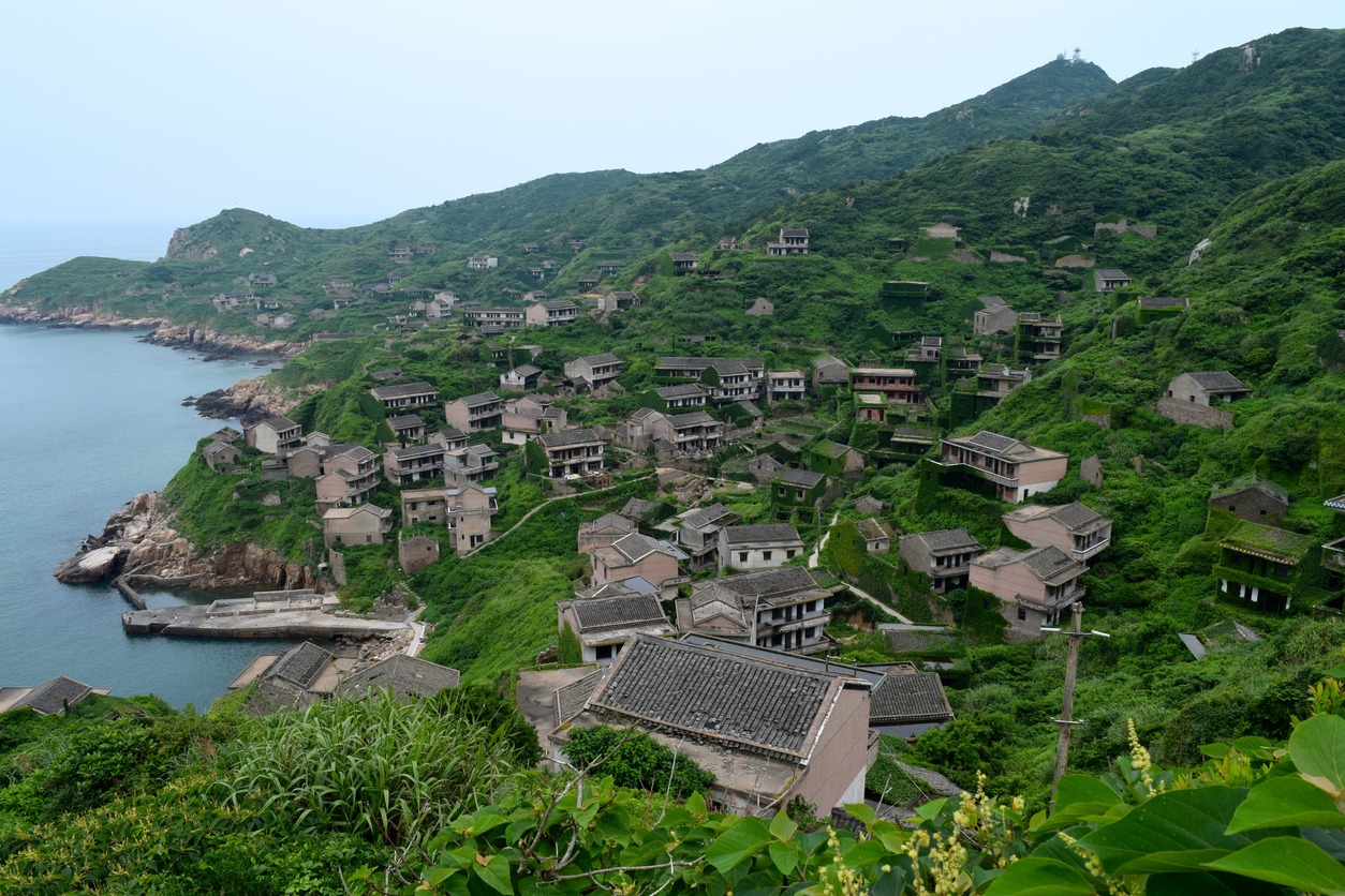 An abandoned Chinese village overgrown with vegetation on the island of Gouqi