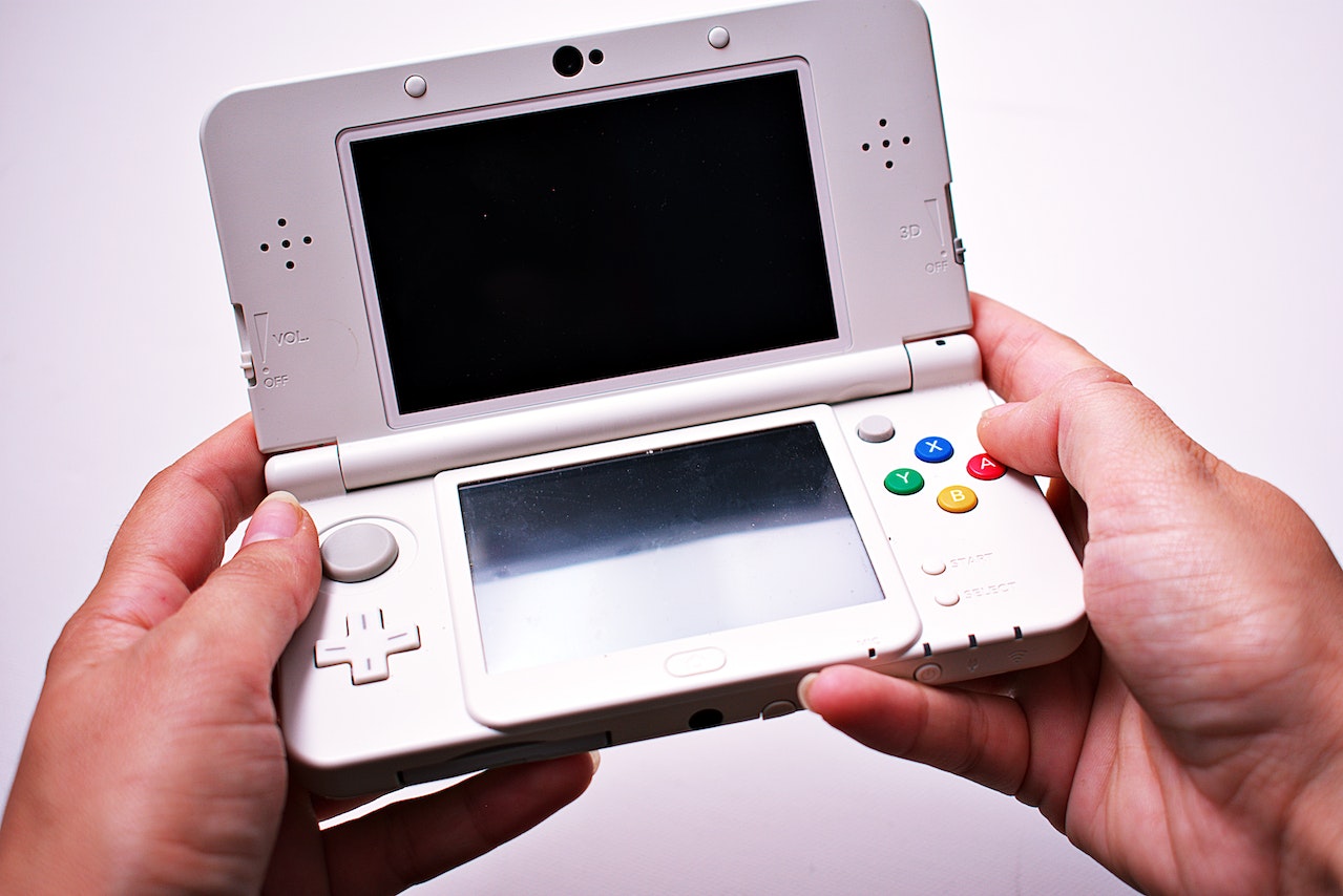 a person holding a Nintendo 3DS
