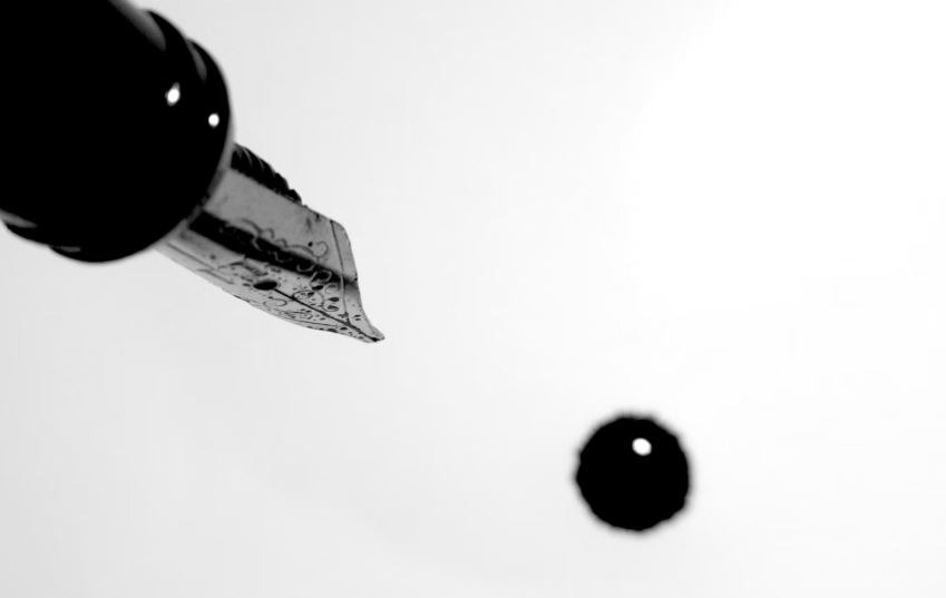 Fountain pen dripping ink photo