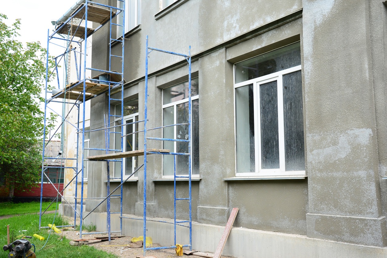 building with stucco being applied