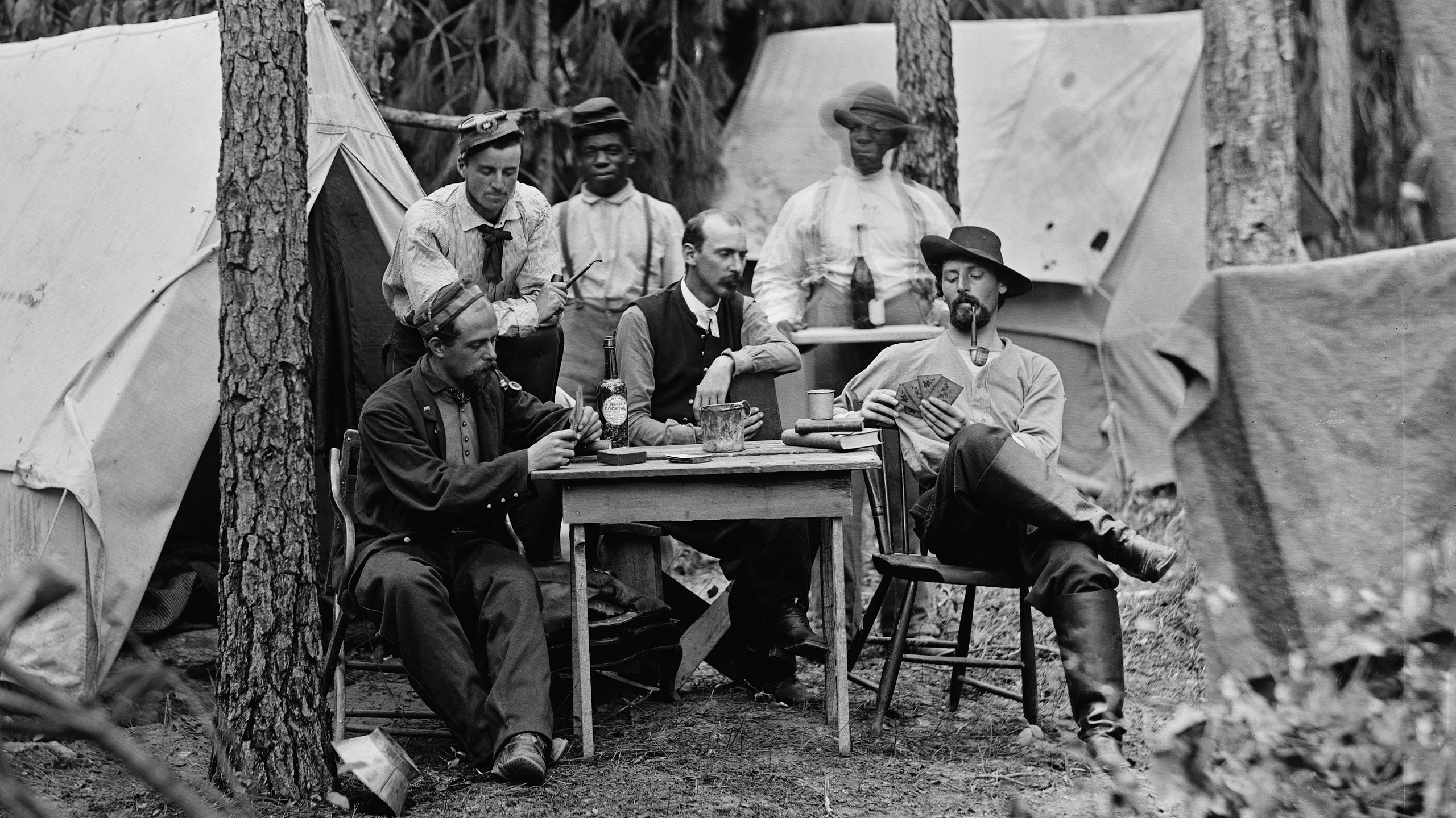 Officers of the 114th Pennsylvania Infantry playing cards in front of tents. Petersburg, Virginia, August 1864