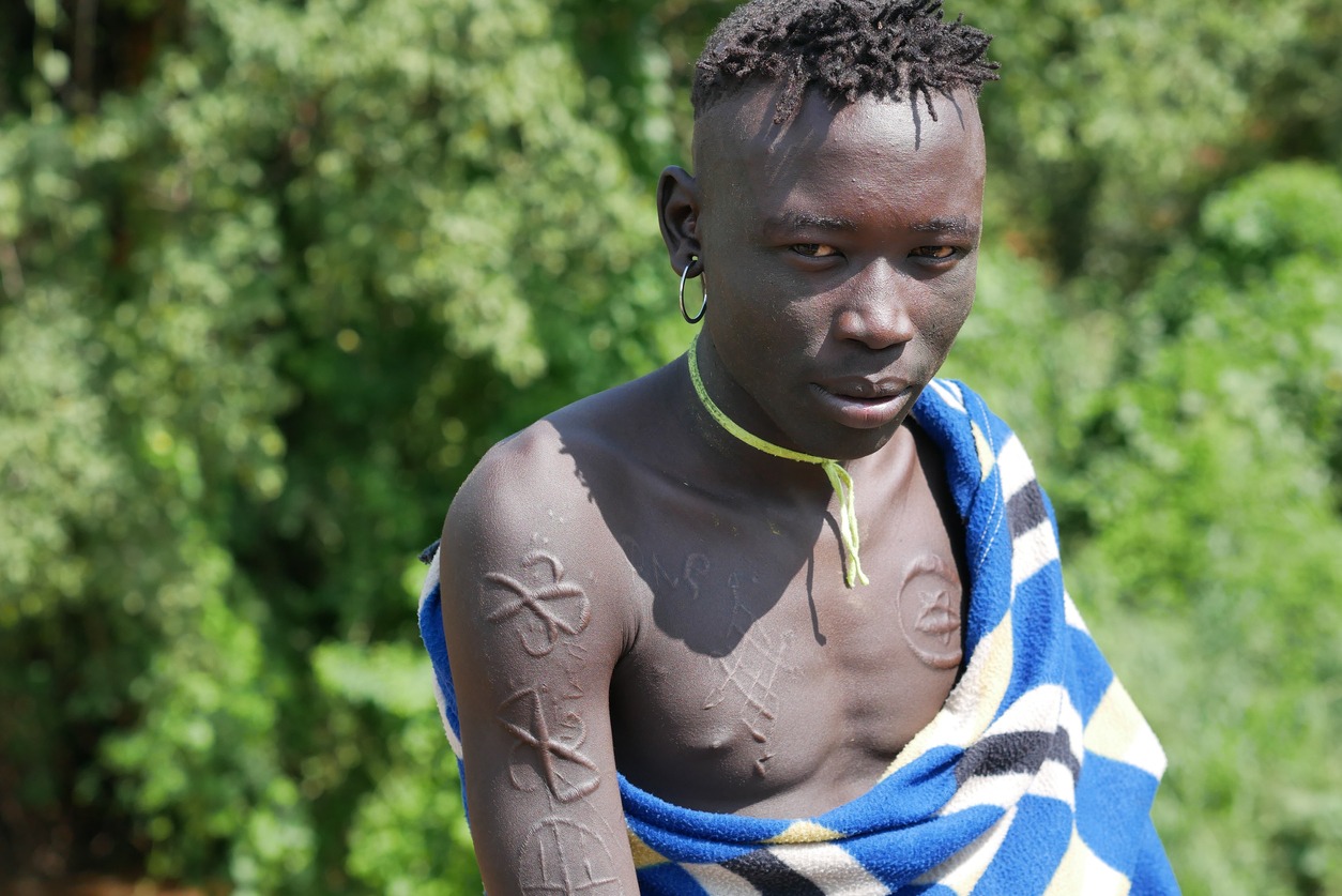Young Mursi man with decorated and scarred skin