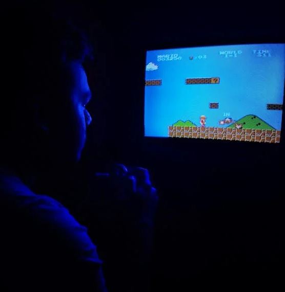 a man playing Super Mario Bros