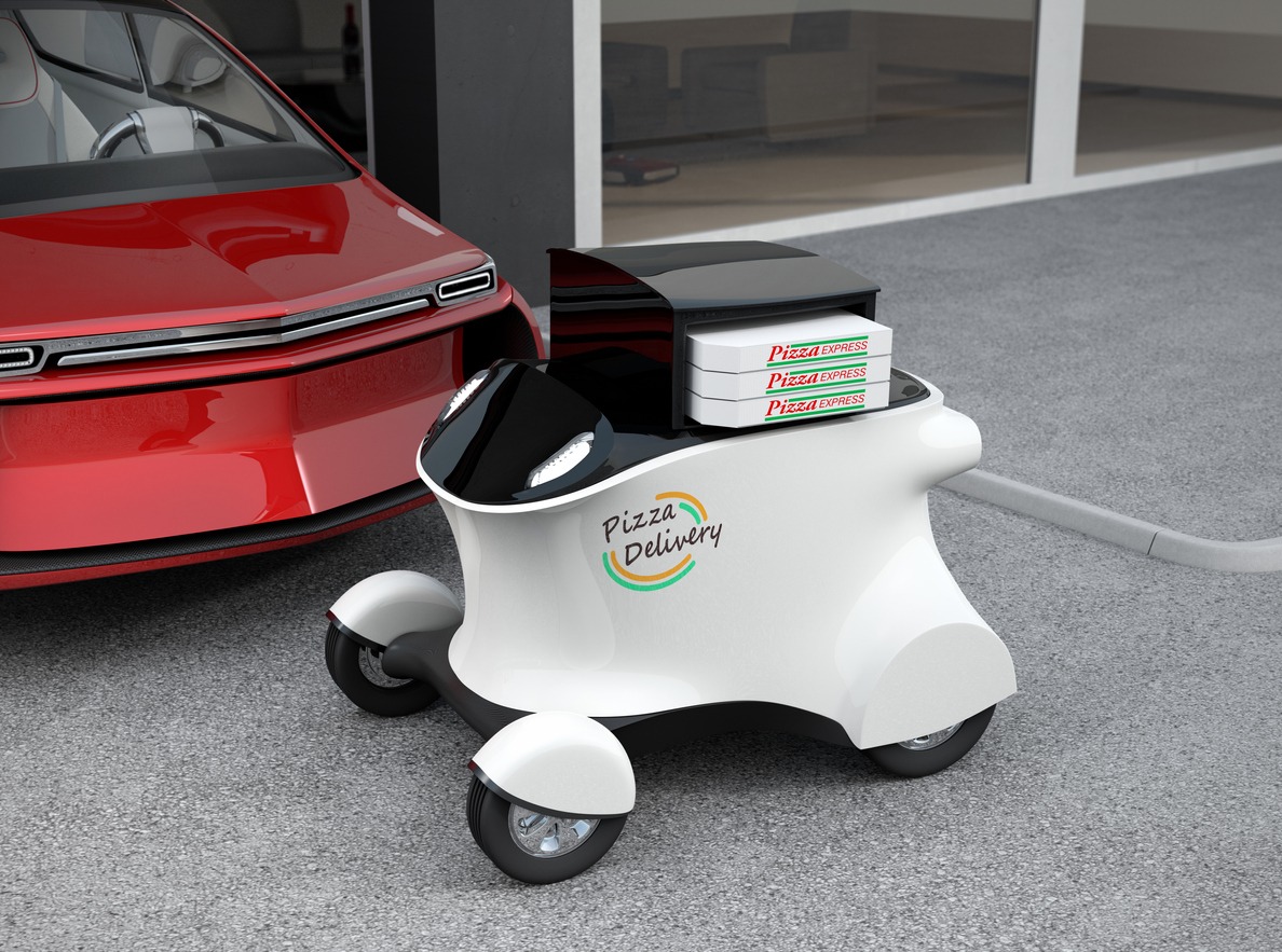Autonomous delivery robot in front of the garage