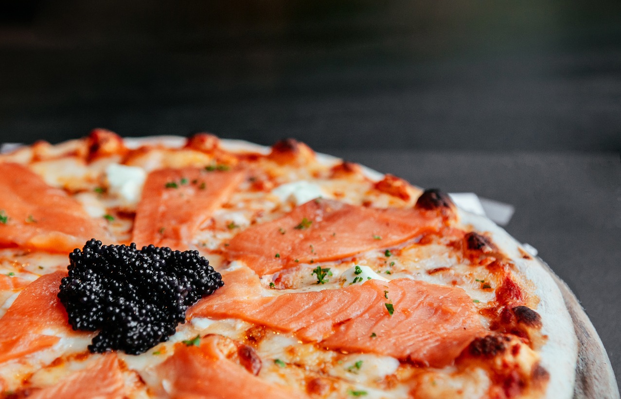 smoke salmon thin crispy italian pizza with black caviar