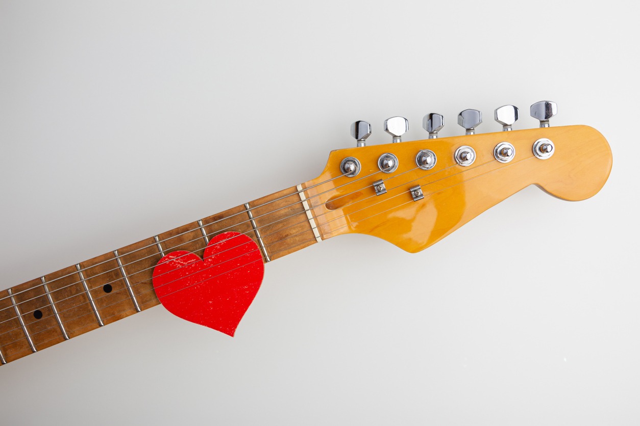 Heart under the strings on the guitar fingerboard