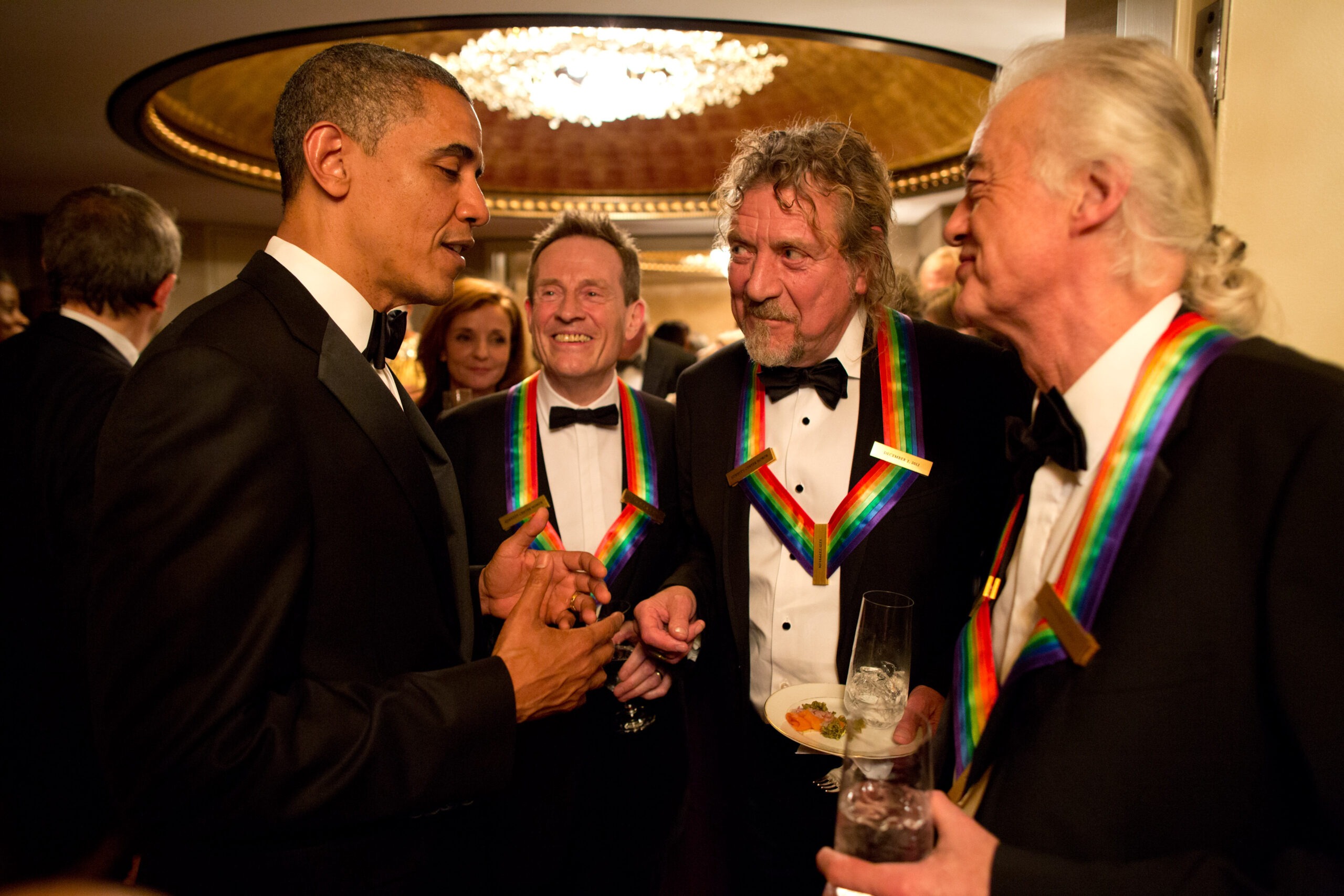 President Barack Obama speaks with the surviving members of Led Zeppelin – John Paul Jones, Robert Plant and Jimmy Page – at the 2012 Kennedy Center Honors event