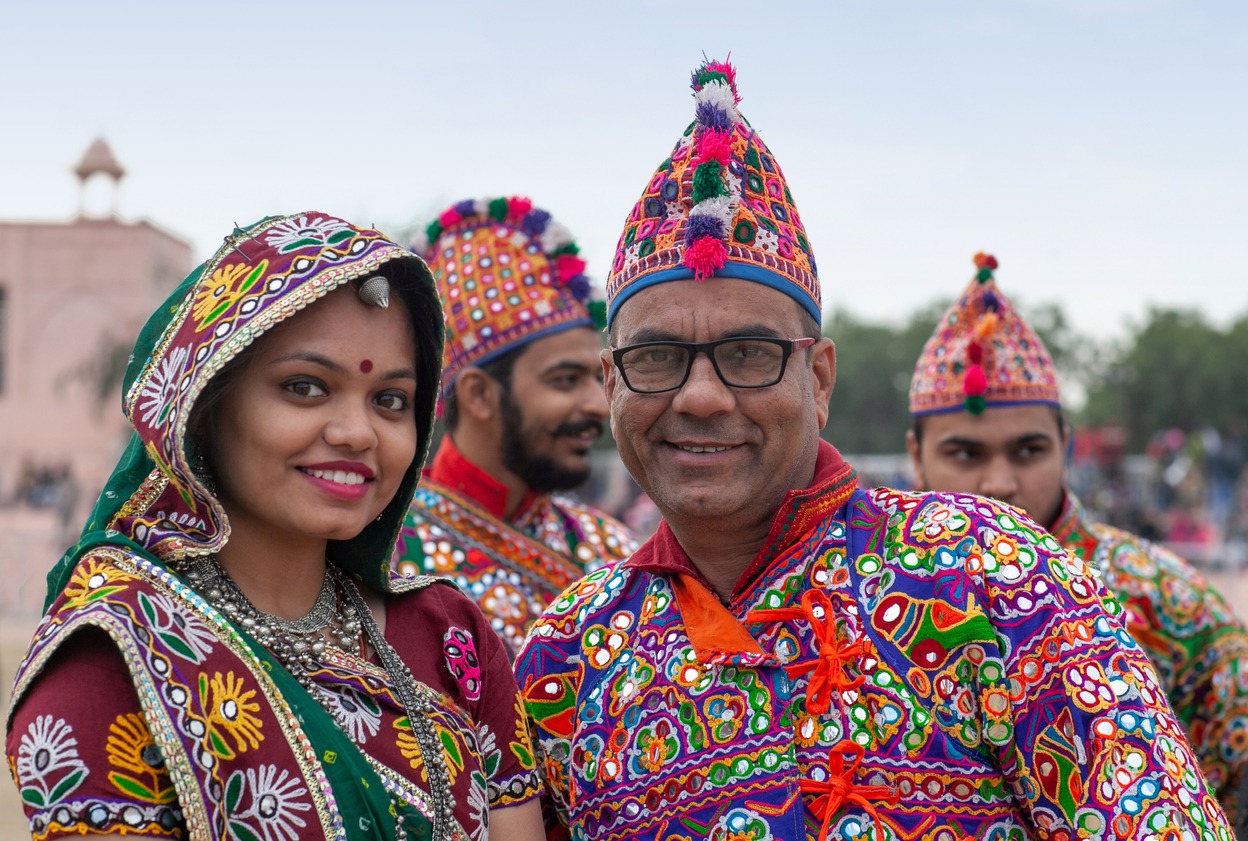 Rajasthani folk dancers performing on festival in Rajasthan state wearing clothes featuring Rajasthan's mirror work.
