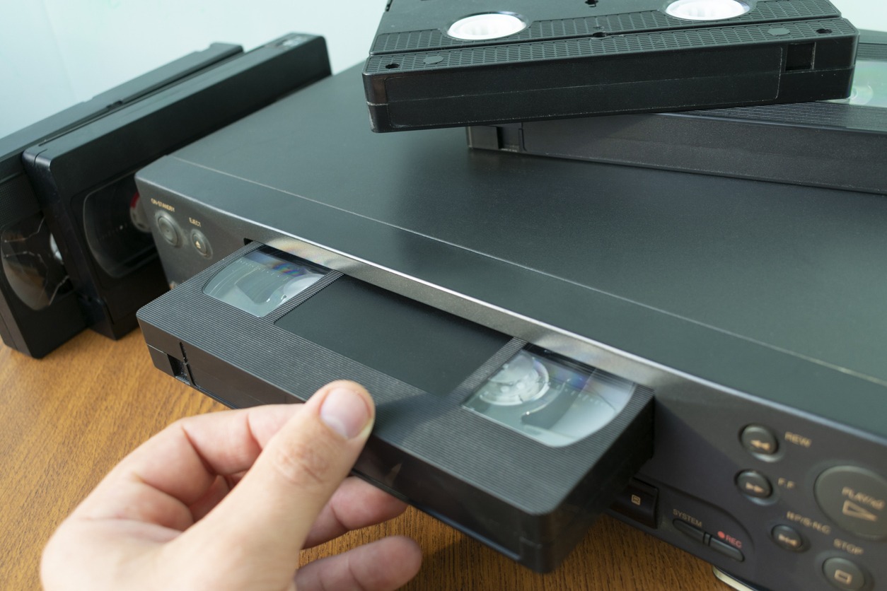 VHS videocassette is put into the video recorder to watch the video
