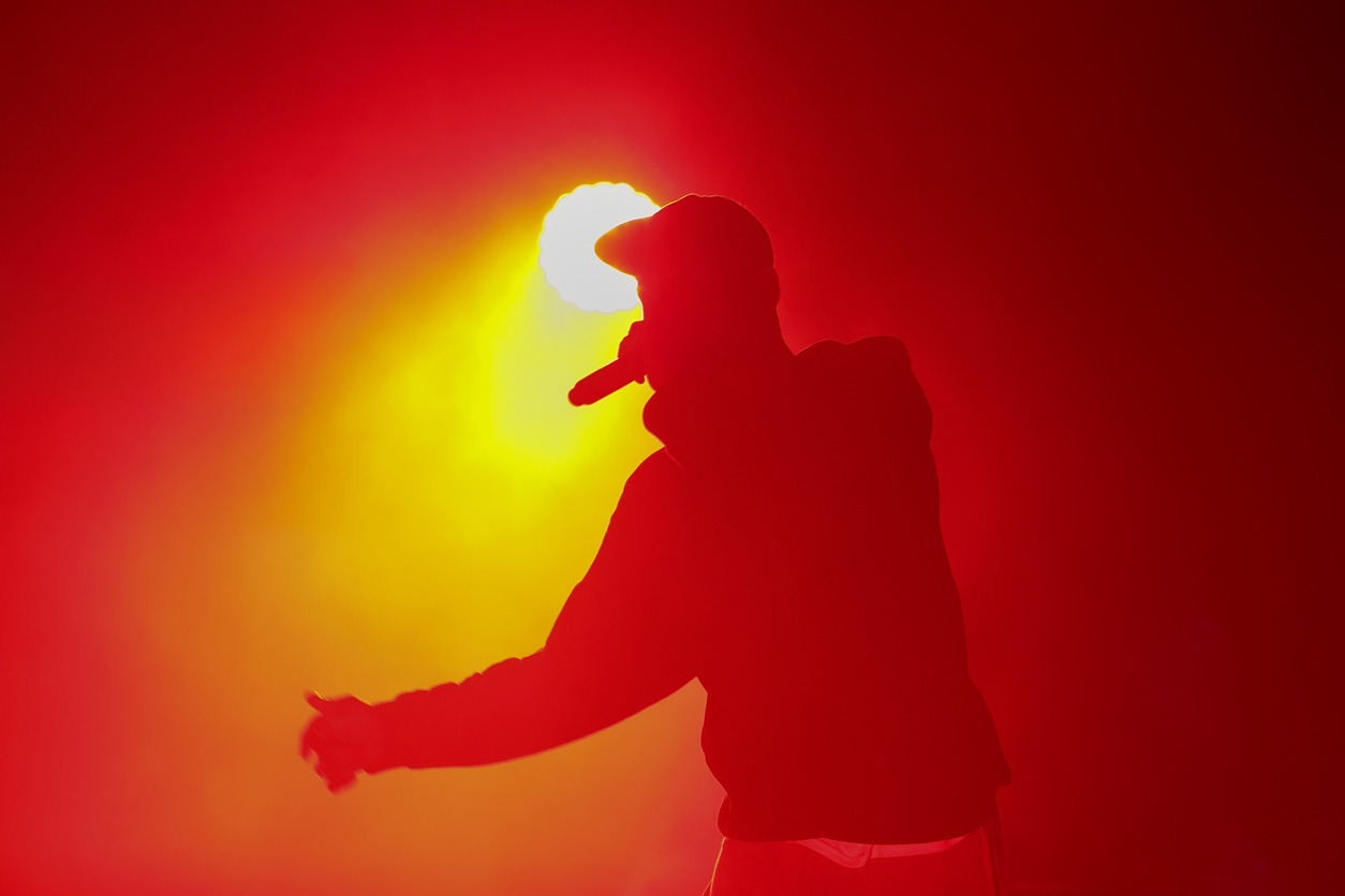 a silhouette of a rap singer with microphone