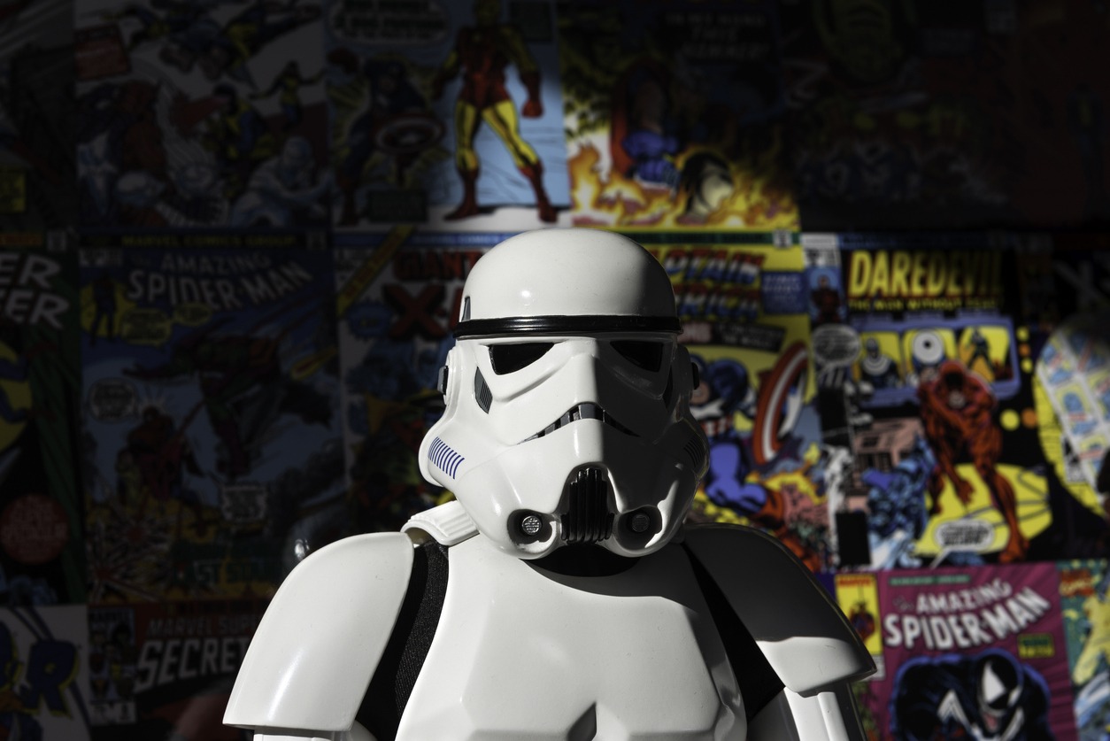 a white Imperial Stormtrooper action figure against a colorful comic book wall