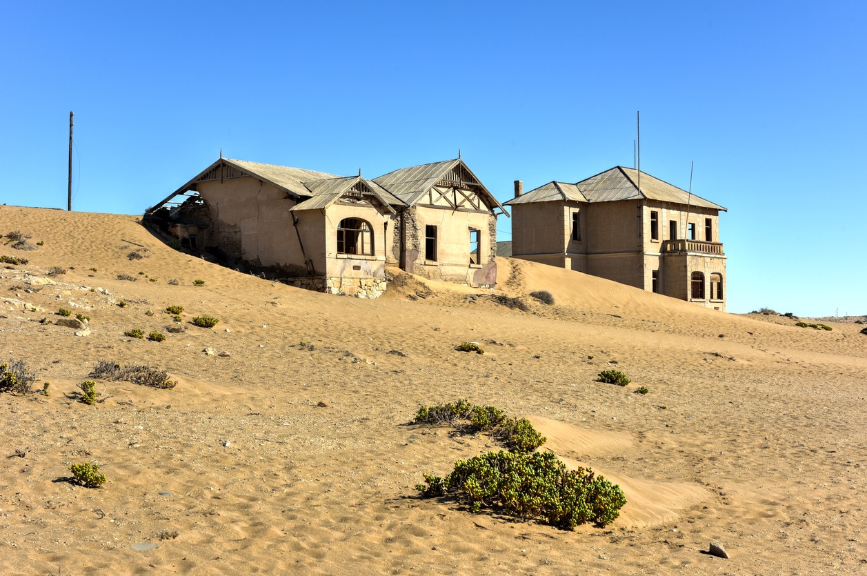 abandoned ghost diamond town of Kolmanskop in Namibia slowly being swallowed by the desert