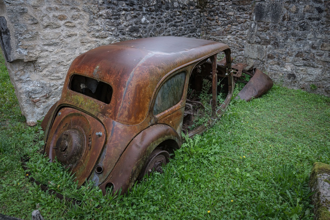 an old Citroen Traction Avant B11 Familiale abandoned and rusty in the village of Oradour-sur-Glane