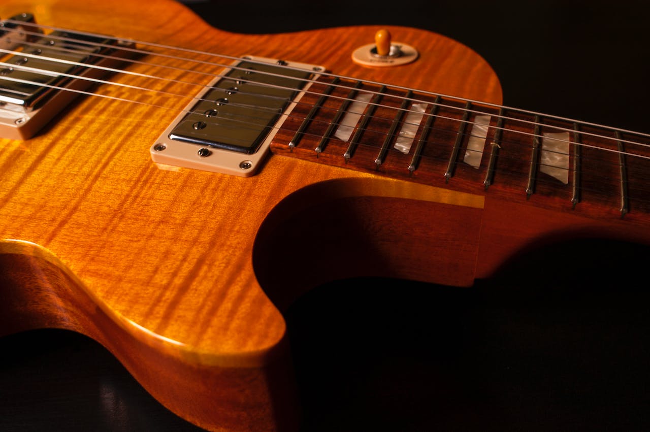 brown and yellow electric guitar