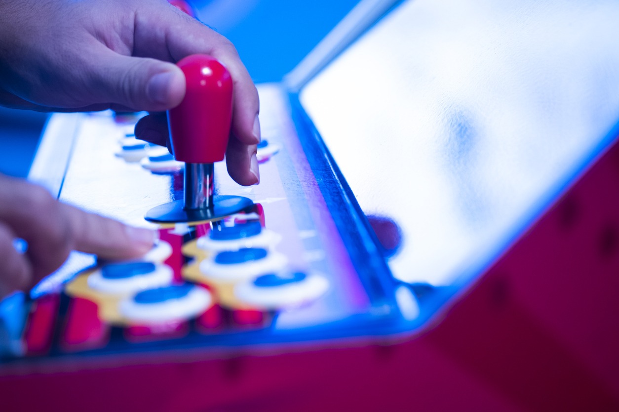 person playing on an arcade machine