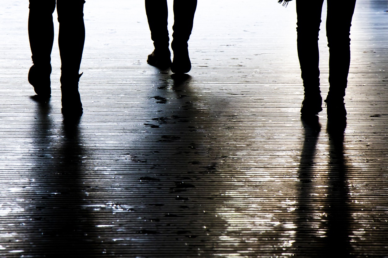 silhouette of people walking at night