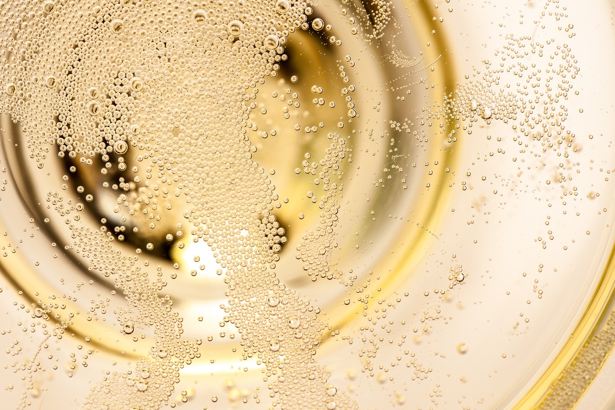 tiny bubbles in a champagne glass