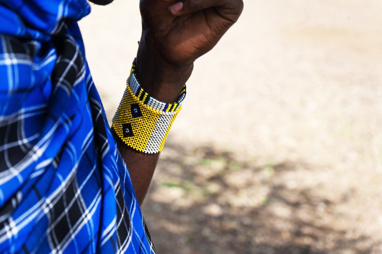 tribal Maasai hand with a colorful bracelet and classic blue color outfit