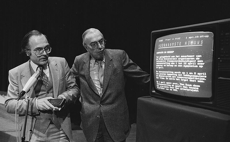 two men looking at Teletext on a TV