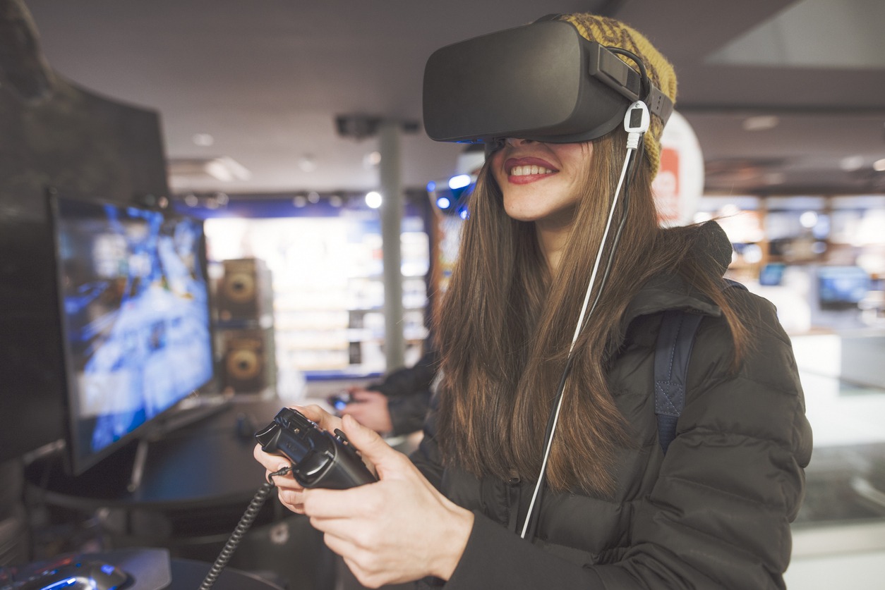 woman playing a game using VR goggles