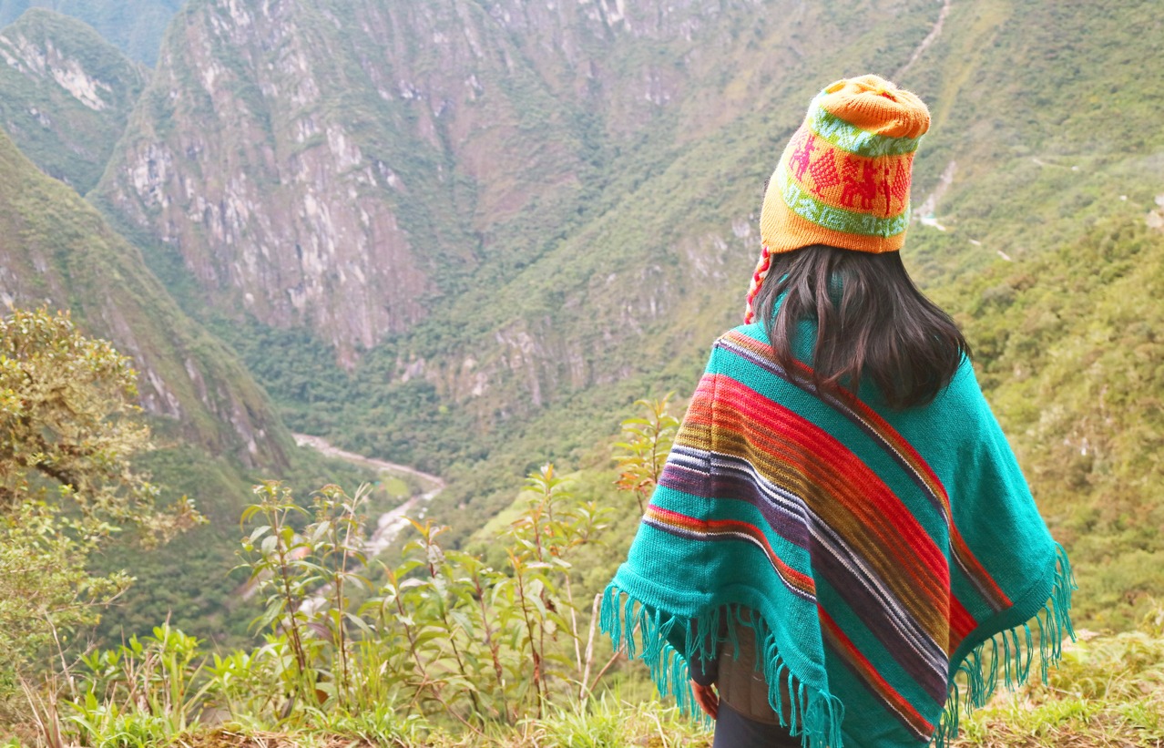woman wearing a chullo hat enjoying the view