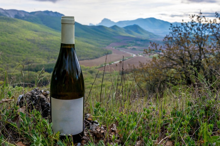 a bottle of wine in the mountains